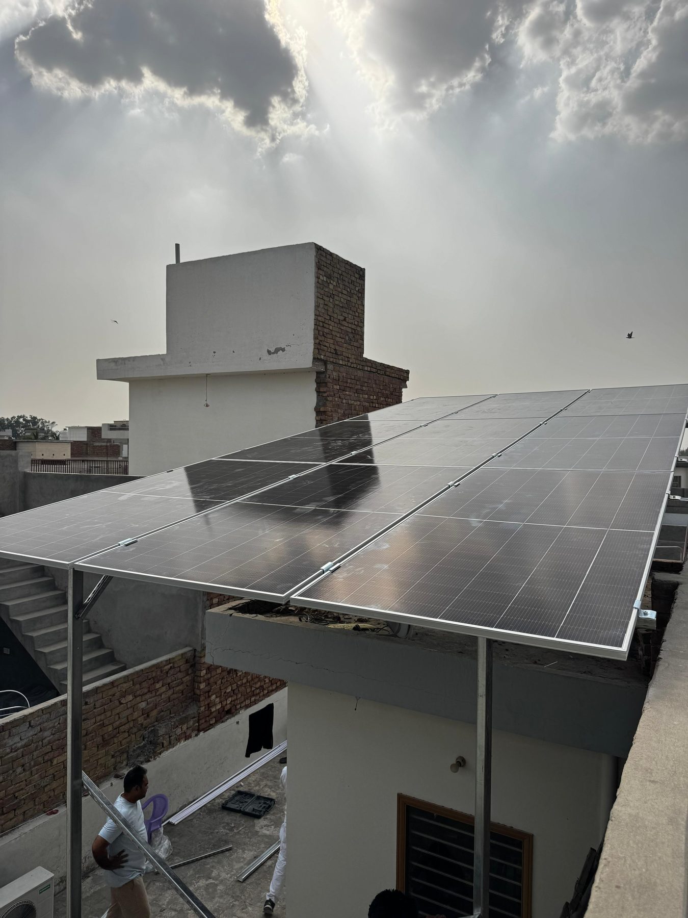 Vayunandan Energies team installing solar panels on a rooftop in Shri Muktsar Sahib